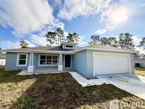 A two-story house with a garage and a driveway.