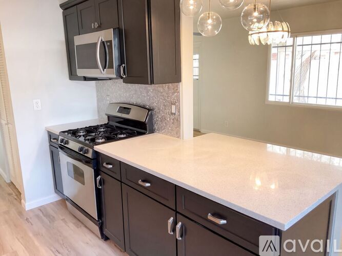 A kitchen with a stove top oven and microwave above it.