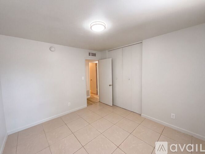 A room with a door and a wall socket.