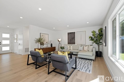 A modern living room with a grey sofa, a wooden bench, and a coffee table.