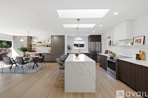 A modern kitchen with a dining table and chairs.