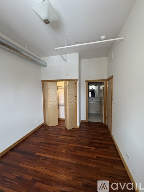 A room with wooden floors and white walls.
