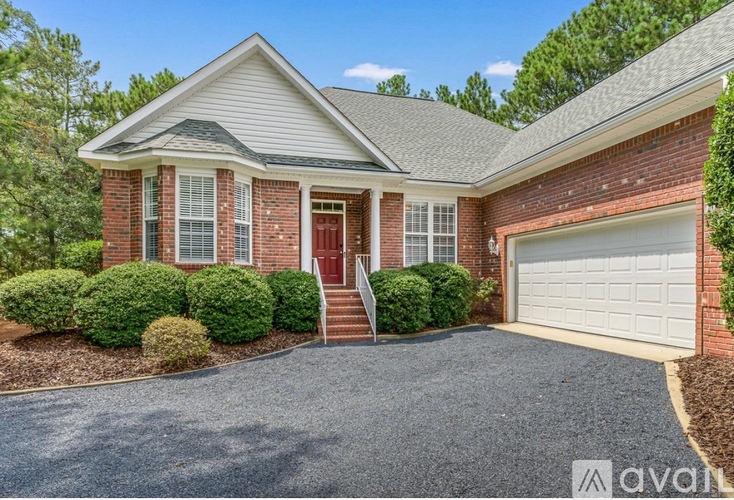 A house with a red door and a garage door.