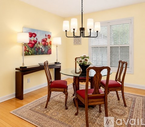 A dining room with a table set for four.
