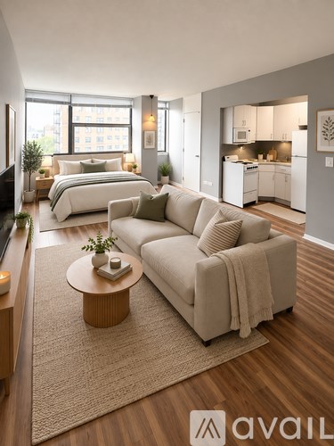 A living room with a couch, a bed, and a television.