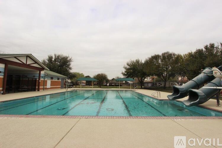 A large outdoor swimming pool with a slide.