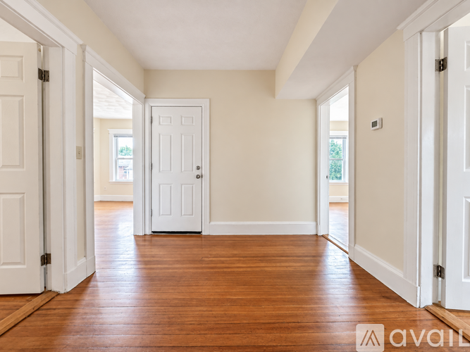 A room with wooden floors and white doors.