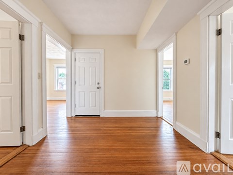 A room with wooden floors and white doors.