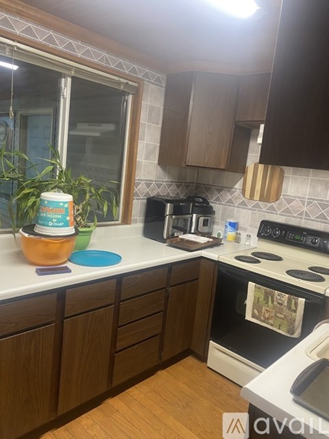 A kitchen with a white countertop and a black stove.