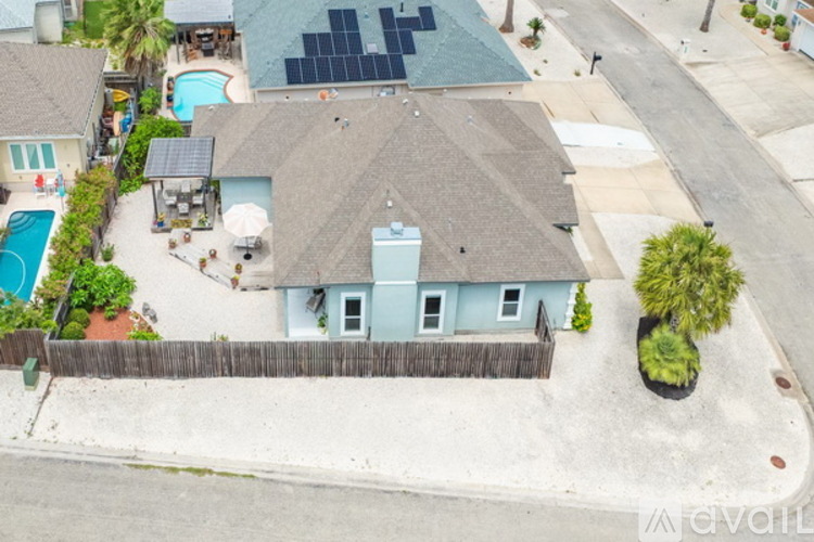 A house with a pool and a fence.
