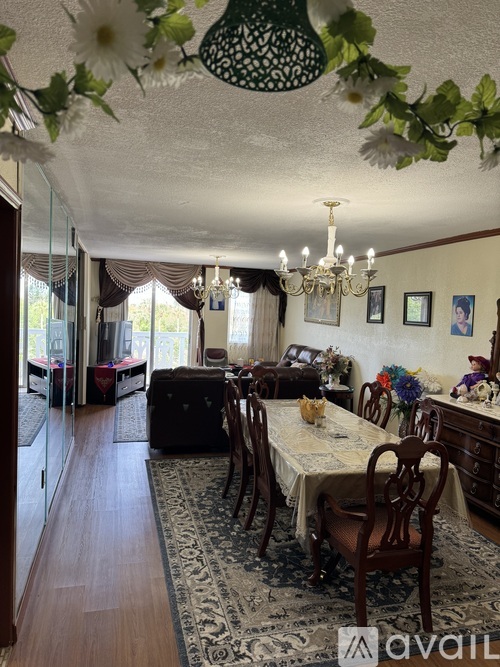 A dining room with a table set for a meal.