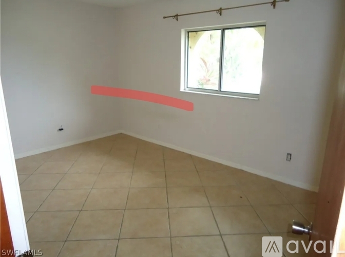 A room with a window and a red line on the wall.