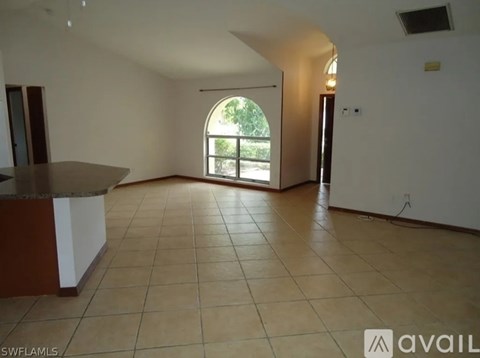 A room with a ceiling fan and a window.