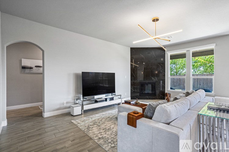 A living room with a grey couch and a television.