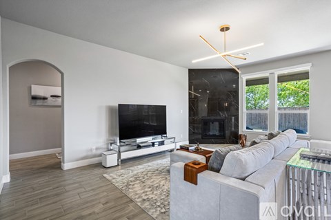 A living room with a grey couch and a television.
