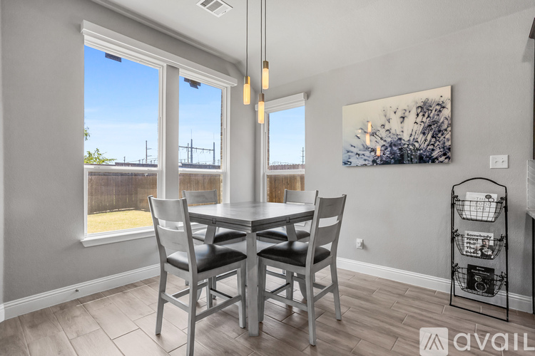 A dining room with a table and chairs.