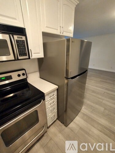 A kitchen with a stainless steel refrigerator and oven.