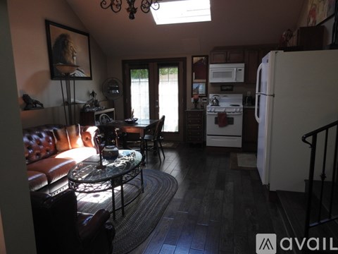A kitchen with a refrigerator, sink, and a window.