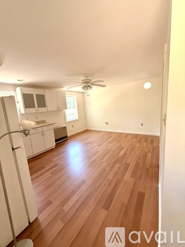 A room with wooden floors and a ceiling fan.