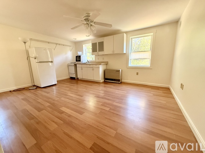 A room with wooden flooring and a ceiling fan.