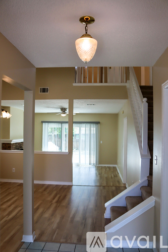 A living room with a staircase leading to the upper floor.