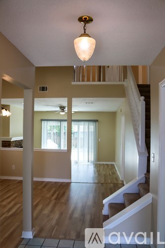 A living room with a staircase leading to the upper floor.