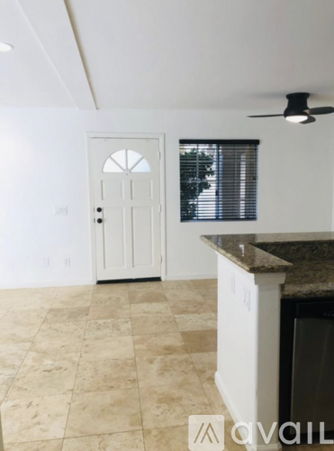 A room with a tiled floor and a ceiling fan.