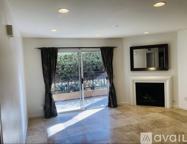A living room with a fireplace and sliding glass doors.