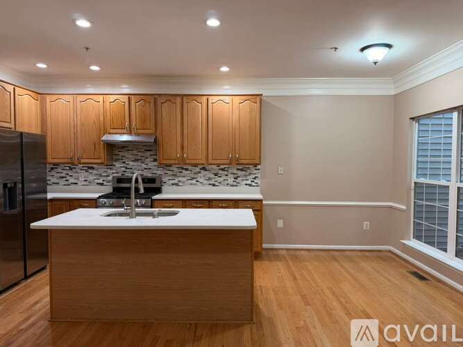 A kitchen with wooden cabinets and a white countertop.
