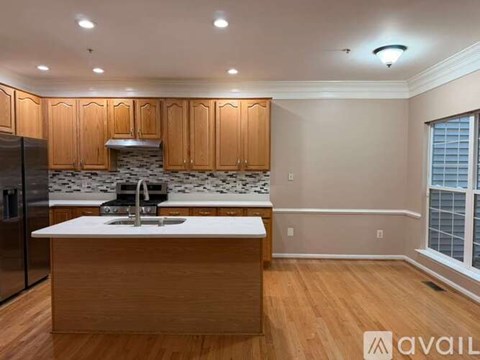 A kitchen with wooden cabinets and a white countertop.