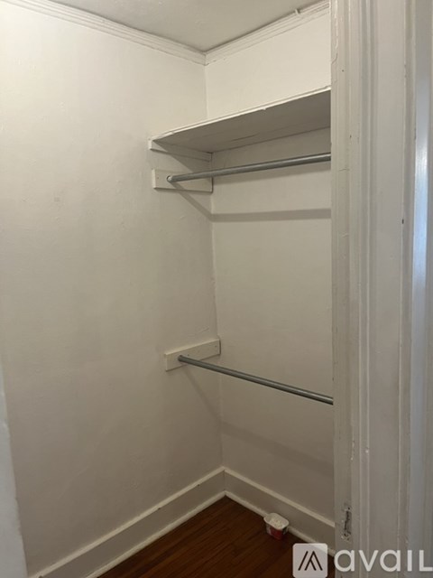 A white closet with a shelf and a rod.
