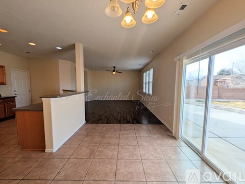 A spacious room with a reception desk and a ceiling fan.