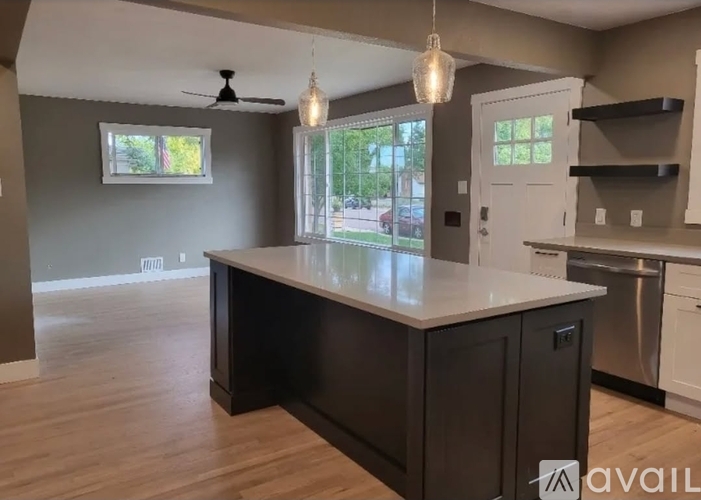 A kitchen with a large island in the middle.