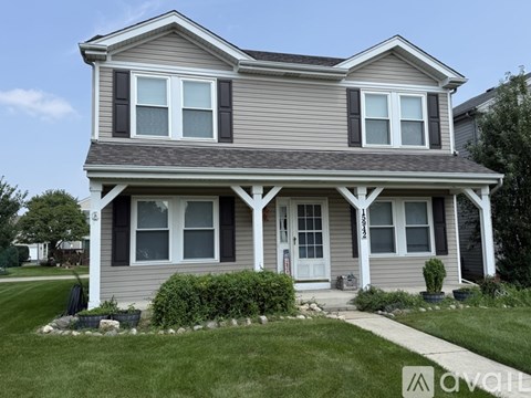 A two-story house with a grey and white exterior.