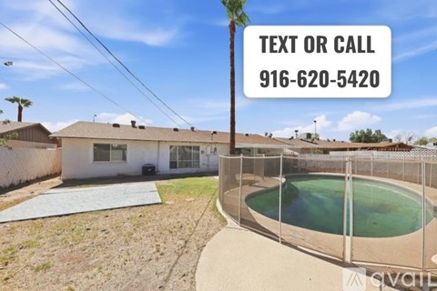 A house with a pool and a sign that says "TEXT OR CALL 916-620-5420".