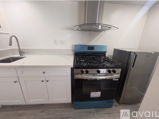 A kitchen with a stove and oven in it.