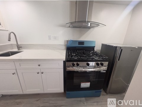 A kitchen with a stove and oven in it.