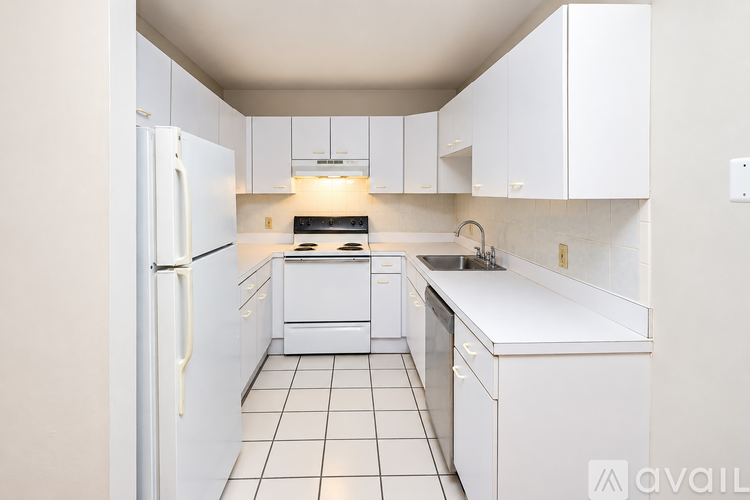 A kitchen with white appliances and cabinets.