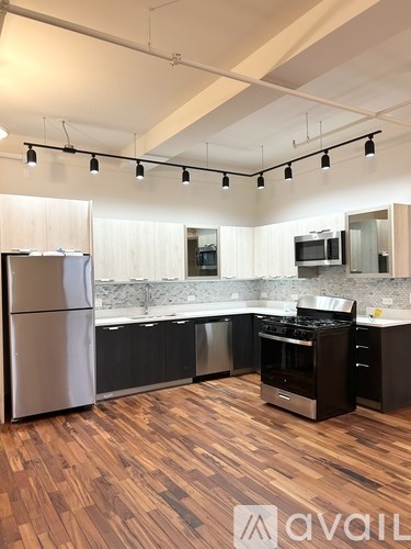 A kitchen with wooden floors and modern appliances.
