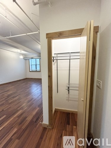 A room with wooden floors and a white door.
