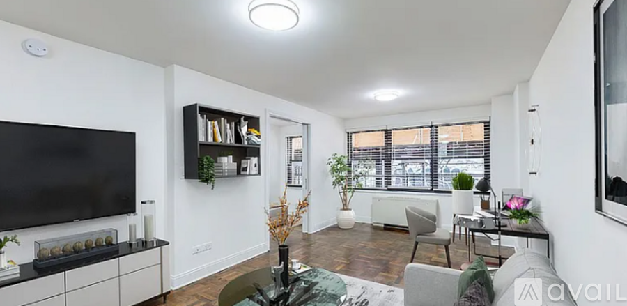A living room with a television, a sofa, and a coffee table.