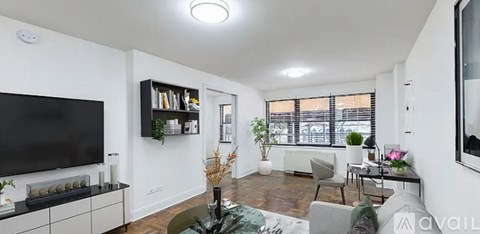 A living room with a television, a sofa, and a coffee table.