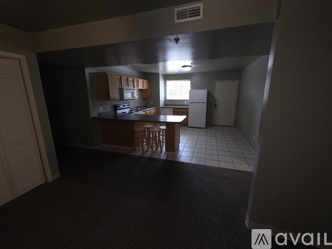 A kitchen area with a dining table and chairs.