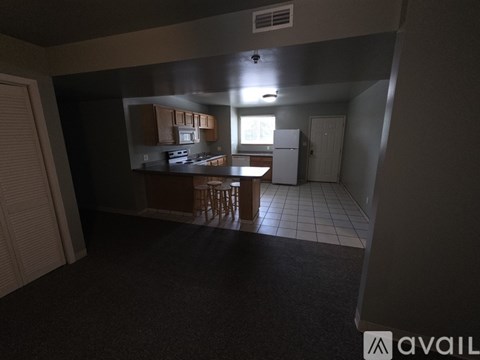 A kitchen area with a dining table and chairs.