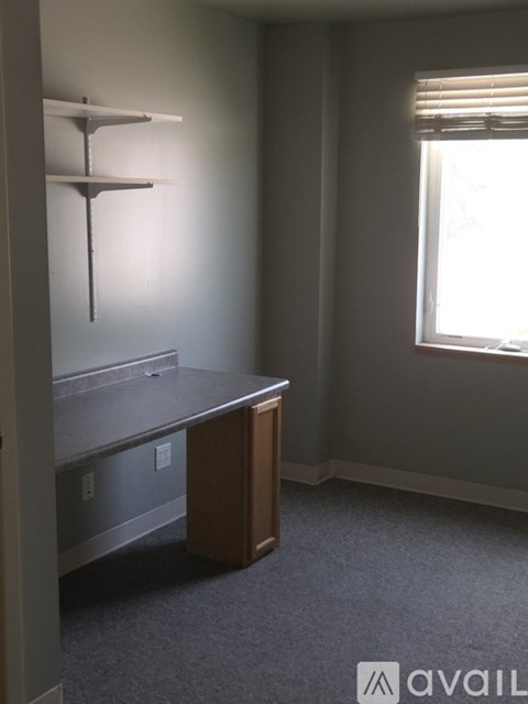 A room with a desk and a window.