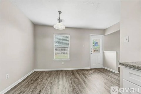 A room with a white door and a window with blinds.