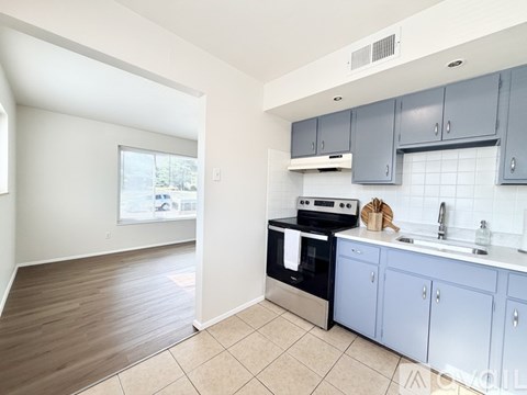 A kitchen with a stove, oven, and cabinets.