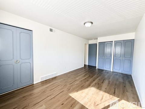 A room with a wooden floor and white walls.