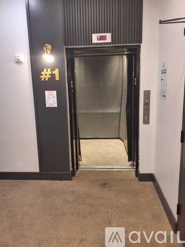 A black door with a glass panel and a sign that says #1.