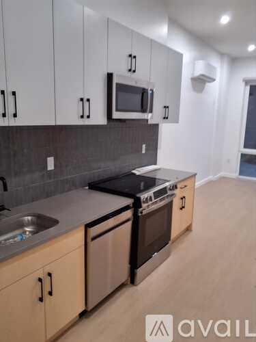 A kitchen with wooden cabinets and a black stove top oven.